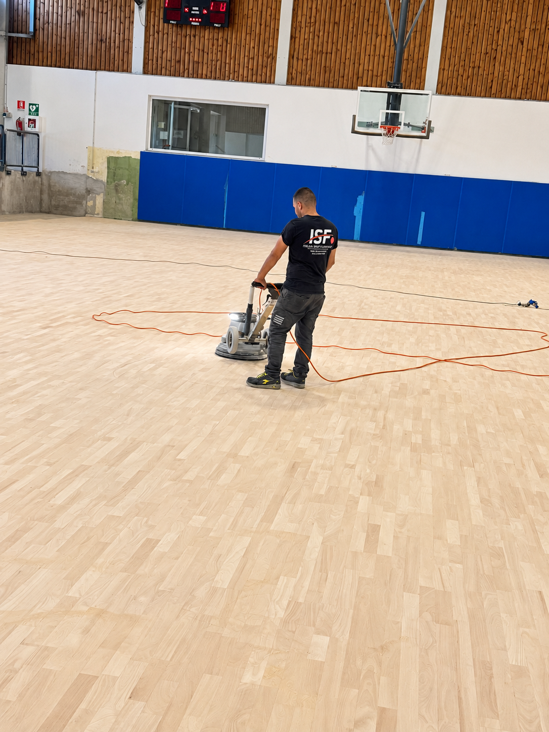 Levigatura professionale di un parquet sportivo con macchinario dedicato